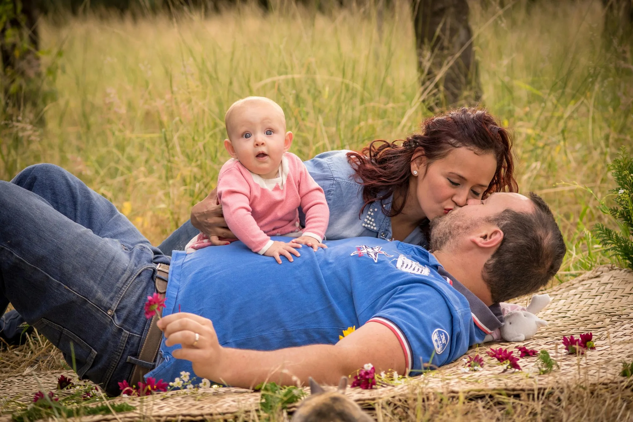 A family lying in the grass